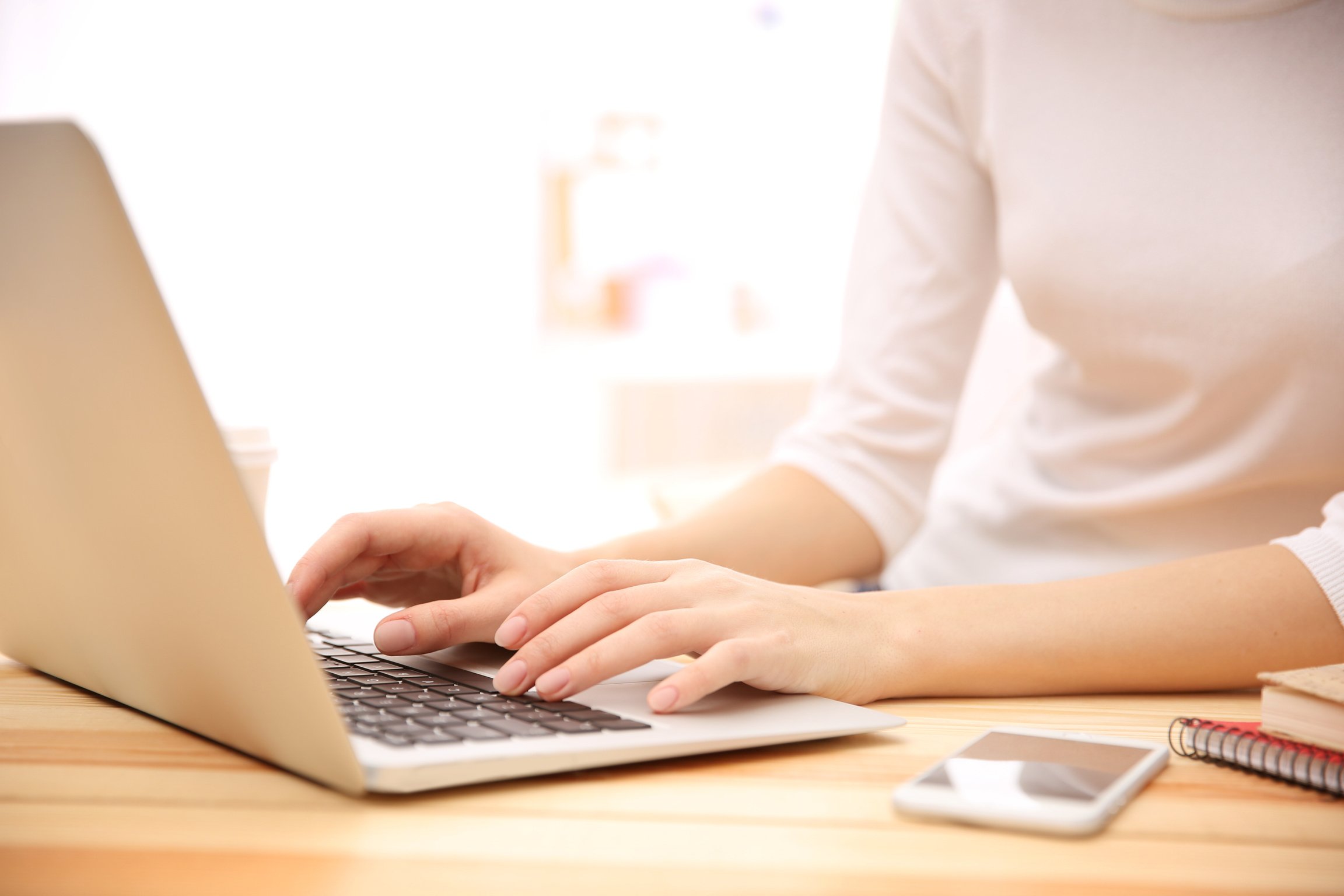 Young Woman Working on Laptop at Home